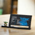 LEGO Star Wars Grogu display plaque features a black plastic information panel with blue character artwork, a small green Grogu minifigure, and a stand on a tabletop background.