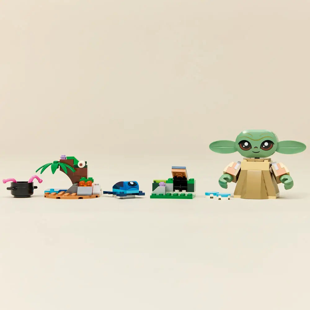 LEGO Star Wars Grogu’s Homestead set displayed in a row on a neutral surface, showing Grogu figure, small landscape builds, blue creature, food elements, and accessories arranged for scale.