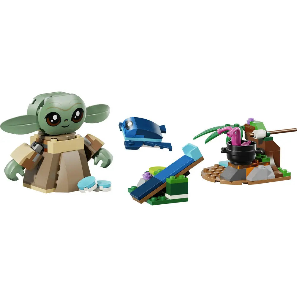 LEGO Star Wars Grogu buildable figure in light green, tan, and beige plastic with oversized ears, rounded head, robe-style body, and small blue accessories, displayed with mini scenery builds on a white background.