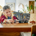 LEGO Star Wars Offworld Sandcrawler in gray plastic sits on a wooden table with minifigures and a brown Mudhorn as a young builder plays with its opening front ramp indoors.
