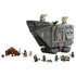 LEGO Star Wars Offworld Sandcrawler in gray plastic features black crawler tracks, tan sails, minifigures, Grogu and a brown Mudhorn arranged on a clean white background.
