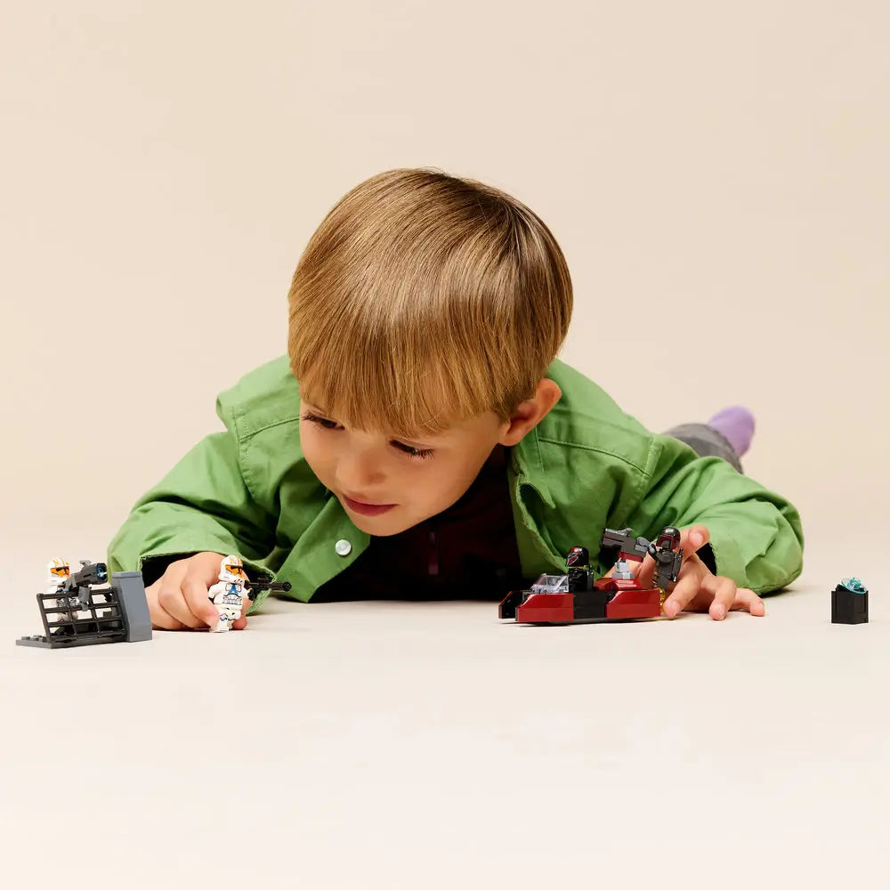 LEGO Star Wars play scene showing a child recreating the Siege of Mandalore battle using Clone Troopers, Mandalorian figures, and vehicles, highlighting hands-on action and imaginative play at home.