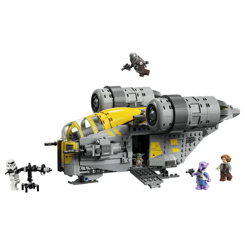LEGO Star Wars Razor Crest building toy, gray and yellow plastic starship with rounded cockpit, twin engine design and adventure theme, displayed with character minifigures on a light background.