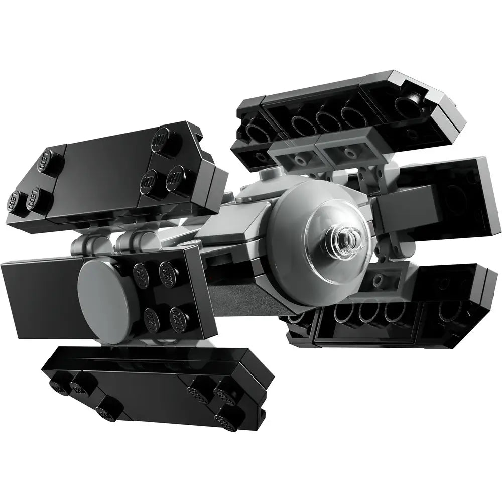 LEGO Star Wars TIE Advanced starfighter built from black and dark gray plastic bricks, angular hexagonal wings around a round cockpit, designed as a small display or play model, isolated on a clean white studio background.
