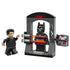 LEGO Batman Bruce Wayne and the Batsuit toy display showing black, gray, and red plastic bricks, Bruce Wayne minifigure, Batman minifigure inside a Batsuit chamber, control panel accessory, and dramatic play features on white.