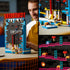 LEGO Donkey Kong Arcade in red, blue and black plastic bricks, shown from the rear with internal mechanisms and close-ups of moving barrels and platform features.