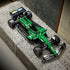 LEGO Technic Aston Martin Aramco AMR25 F1 car in green and black bricks features racing tires, aerodynamic bodywork and sponsor graphics, displayed on a textured bench.