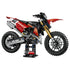 LEGO Technic Ducati Desmo450 MX Factory model in red, black, gold, and silver plastic features knobby tires, detailed engine parts, and a display stand on white.