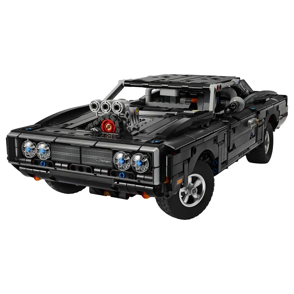 LEGO Technic Dodge Charger R/T in black plastic bricks with silver wheels, four round headlights and exposed supercharger, shown from the front on a white background.