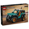 LEGO Technic Jeep Wrangler Rubicon set features a teal and black plastic off road SUV with rugged textured tires, orange rims, and detailed mechanical frame, designed as a realistic vehicle model, shown on branded retail packaging with desert background.