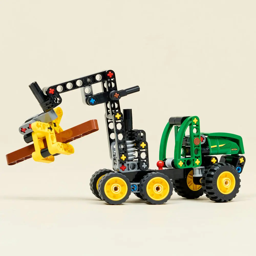 LEGO Technic John Deere 1470H Wheeled Harvester displayed fully built with green cab, yellow wheels, articulated crane, claw-style log grabber, and balanced proportions on a neutral tabletop background.