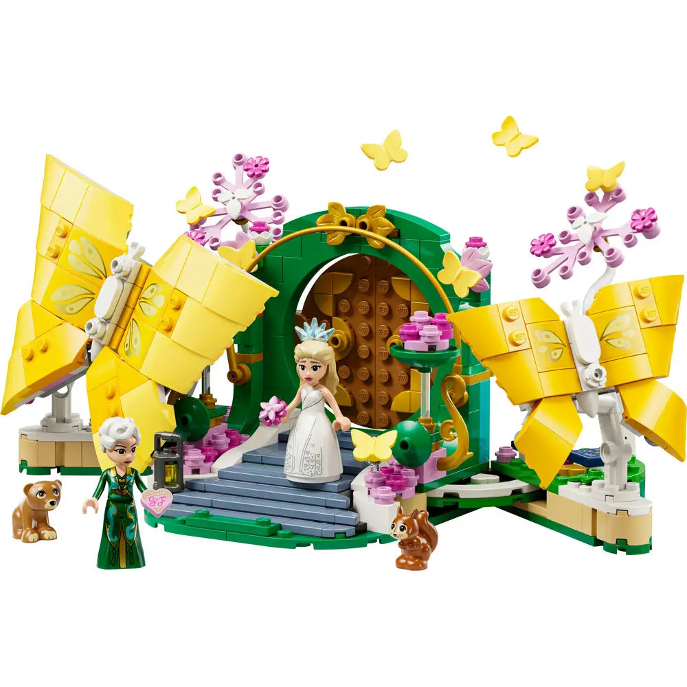 LEGO Wicked Glinda's Wedding Day playset features yellow butterfly builds, green garden arch, pink blossoms, Glinda and Elphaba mini-dolls with animal figures on a clean white background with detailed LEGO elements and realistic display presentation.