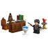 LEGO Harry Potter Dumbledore’s Office toy display showing brown and tan plastic bricks, desk with books and Sorting Hat, blue Pensieve bowl, red phoenix perch, and Harry Potter minifigure holding a wand on white.