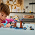 LEGO Harry Potter Forbidden Forest play scene shows a child in a pink top holding a translucent blue stag beside brown brick trees, Dementors, Harry Potter, and Sirius Black.