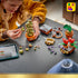 LEGO Harry Potter Hogwarts Herbology Plants building scene shows a child adding green pieces to Mimbulus Mimbletonia, with a Mandrake, red flowers, loose bricks, and a tablet.