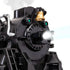Close-up of Lionel Polar Express steam locomotive front showing headlight beam, golden bell, and smoke emission, highlighting LED lighting and steam realism details.