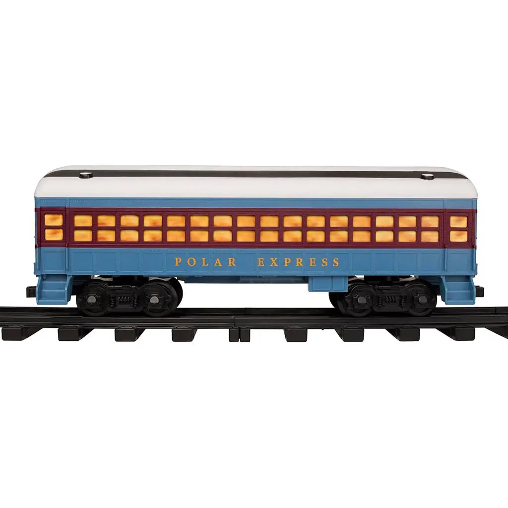 Blue and red Lionel Polar Express passenger car with glowing yellow windows and gold lettering, sitting on black model train tracks, showcasing realistic holiday train detailing.