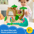Toddler girl playing with Fisher-Price Little People Disney Moana Adventure Village playset featuring Moana and HeiHei figures, palm trees, and ocean wave design.