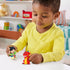 Disney Princess Belle toy play scene by Fisher-Price Little People with child playing with figure set, colorful toys and nursery furniture visible in softly lit indoor background