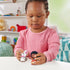 Disney Princess Moana toy play scene by Fisher-Price Little People with child holding brown Moana figure and white pig Pua, colorful nursery setting with shelves, toys, and soft indoor lighting
