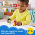 Disney Princess Mulan toy play scene by Fisher-Price Little People with child holding multicolor Mulan figure and red dragon Mushu, colorful nursery setting with shelves and toys behind