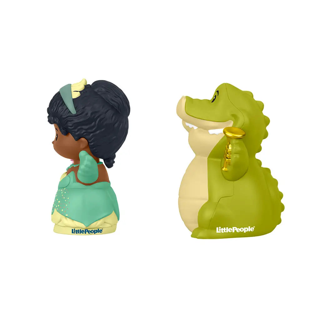 Disney Princess Tiana and Louis Little People toy figures with glossy plastic finish and rounded shapes, side profile view of princess holding flower and crocodile holding trumpet, isolated on white background.