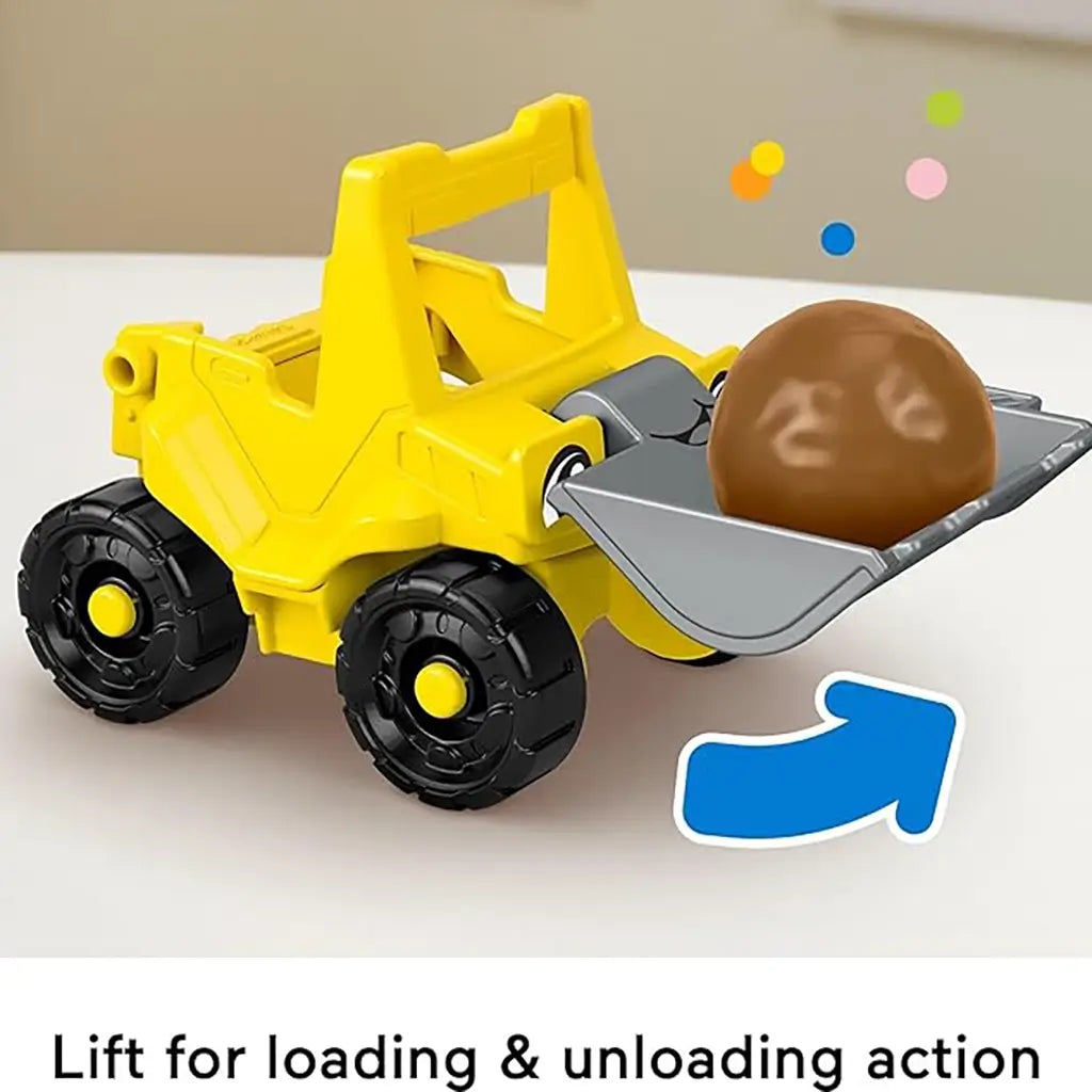 Fisher-Price yellow toy bulldozer lifting a brown play ball in its silver scoop, demonstrating loading and unloading action for toddler construction play.