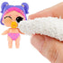 Close-up of an L.O.L. Surprise! baby doll with purple hair and pink diaper as a hand uses a cloth to reveal hidden eye color, demonstrating the color-change feature.