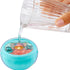 Hand pouring water into an L.O.L. Surprise! Baby Bundle Surprise container to activate a hidden reveal feature, showing the baby doll inside with pastel nursery graphics.