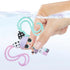 Hand dipping LOL Surprise Hair Beads doll with pastel pink and teal spiral hair into clear water, demonstrating interactive color-change or styling feature.