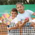 Two smiling kids on a tennis court holding a pickleball paddle and ball from the 3C4G Adventure Fun set, ready to play an energetic outdoor game.