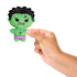 Hand holding Marvel Moodiverse Angry Hulk plush, small green fabric figure with stitched angry eyes, clenched teeth, and purple shorts, compact collectible toy for scale.