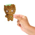Hand holding Marvel Moodiverse Series 1 sad Baby Groot plush, brown fabric with stitched eyes and green fabric detail, demonstrating compact collectible size for play or display.