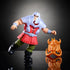 Masters of the Universe Ram Man action figure with silver helmet and armor, red tunic, green pants, and black boots, posed mid-stride beside gold horned mask accessory.