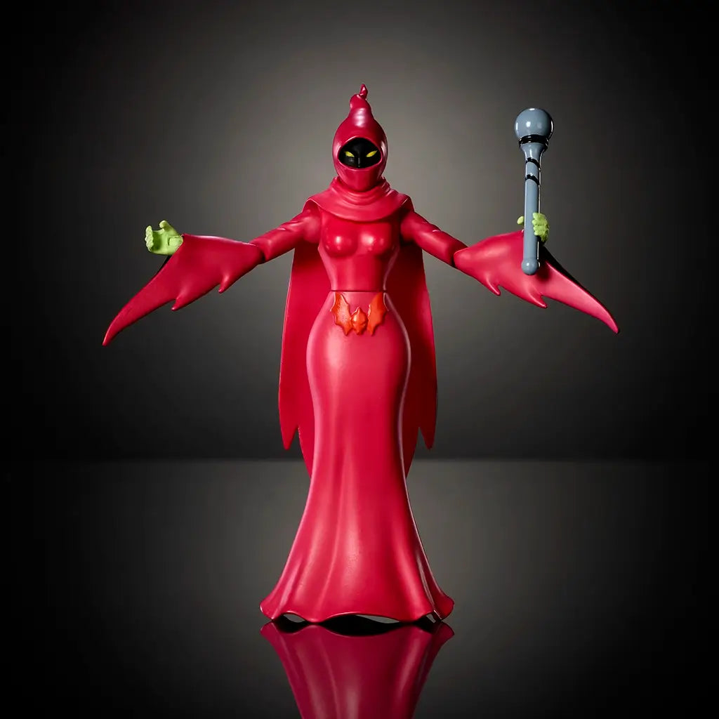 Front view of Shadow Weaver action figure from Masters of the Universe Origins, featuring red plastic hooded gown, smooth sculpted chest and cape, symmetrical stance, holding staff, photographed on a dark reflective surface.