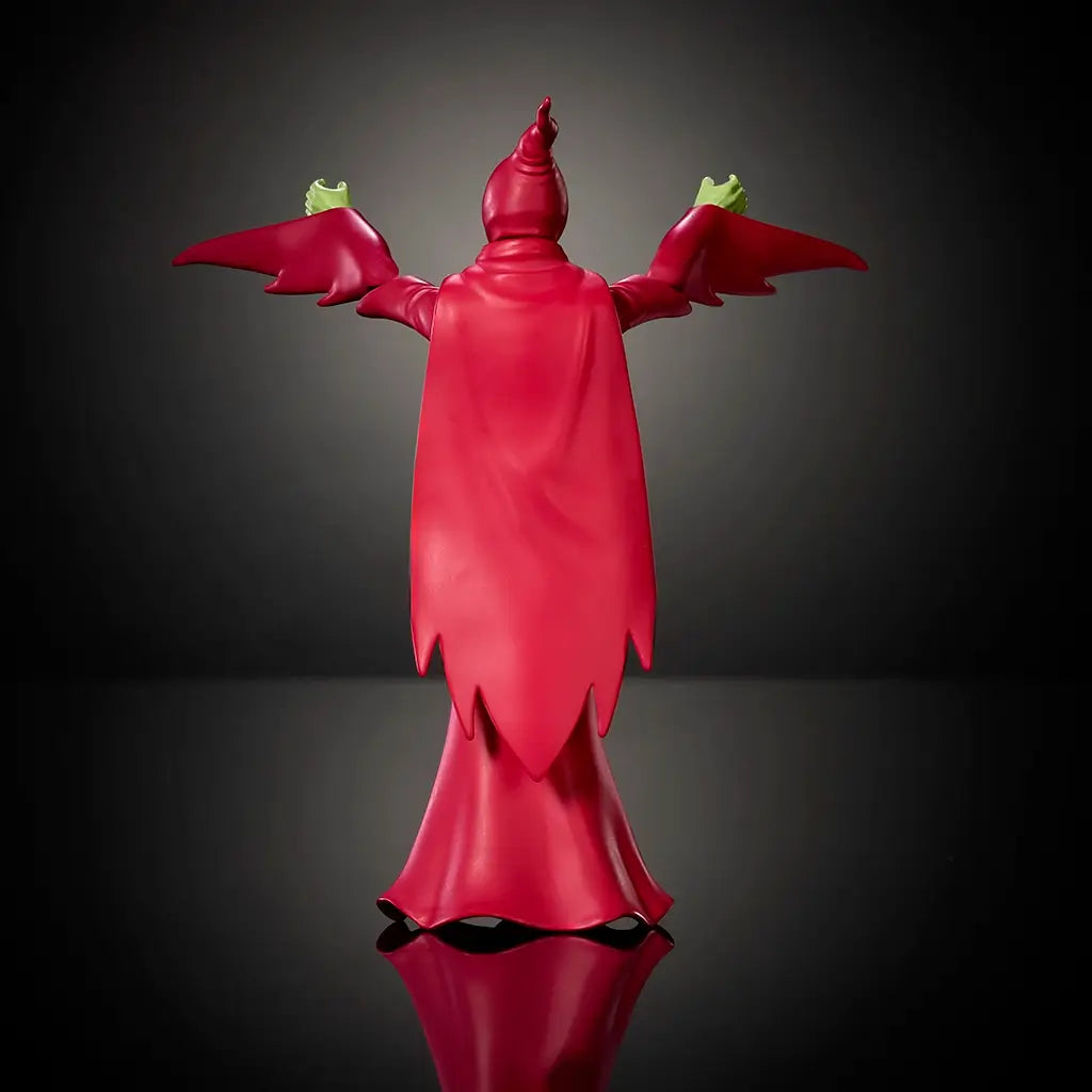 Rear view of Shadow Weaver action figure, highlighting flowing red plastic cape with jagged hem, smooth molded texture, raised arms pose, and full back silhouette photographed on a dark studio background.