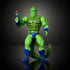 Front view of Whiplash action figure from Masters of the Universe Origins, showing green sculpted muscles, armored chest texture, blue boots and wristbands, fierce facial expression, posed on a dark studio backdrop.