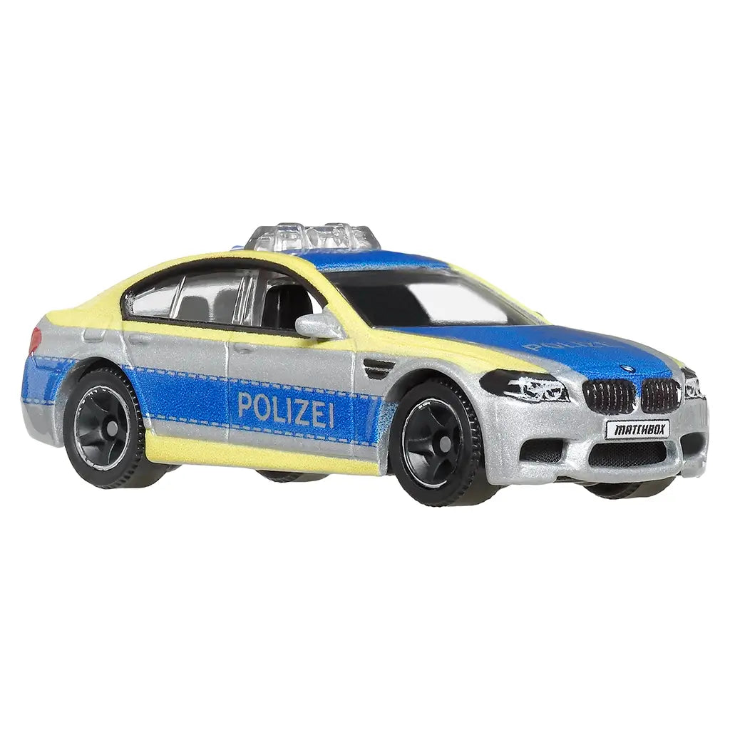 Matchbox BMW M5 Police diecast car in 1:64 scale, silver with blue and yellow Polizei livery, black wheels, and rooftop light bar, shown angled on white background.