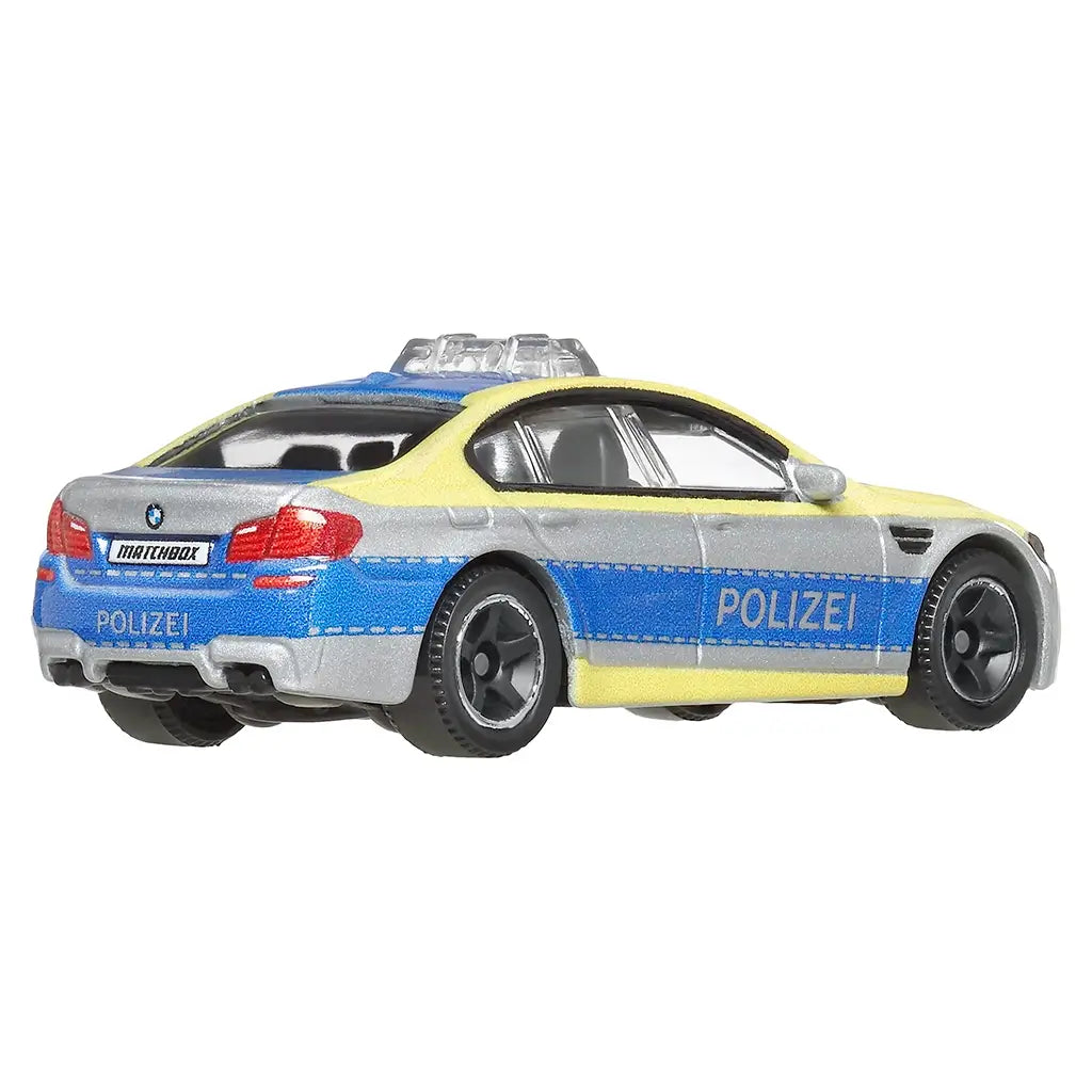 Matchbox BMW M5 Police diecast vehicle 1:64 scale shown from rear angled view, silver with blue and yellow Polizei design, black wheels, and detailed rear lights.