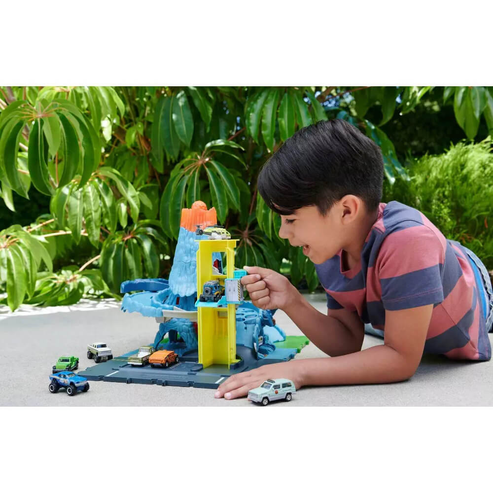 child playing with the Matchbox Action Drivers Matchbox Volcano Escape Playset