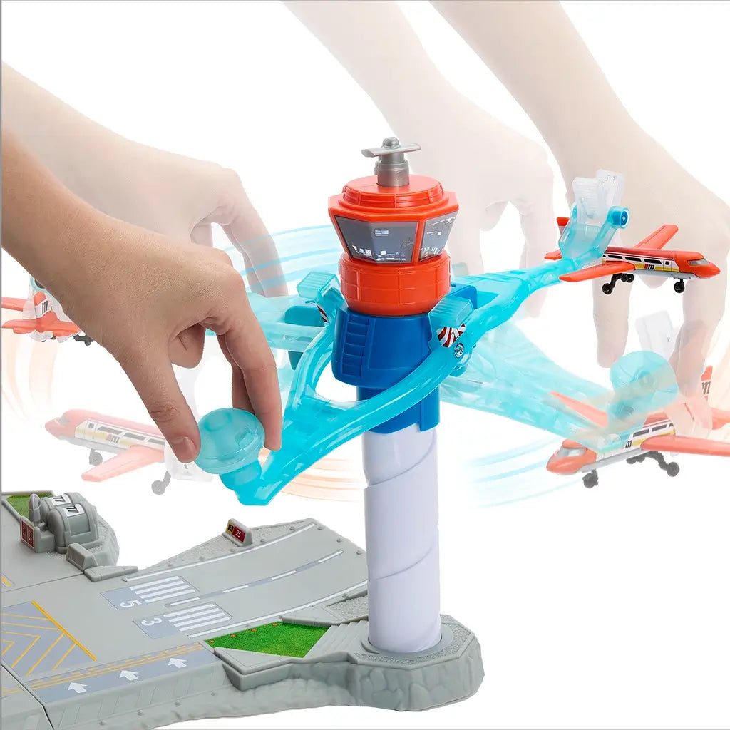 Matchbox Airport Takeoff Adventure playset featuring a tall blue and orange tower with moving transparent blue arms launching toy planes, operated by a hand motion lever.