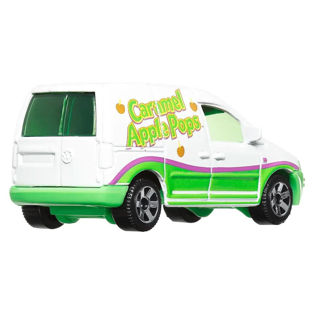 Rear angled view of Matchbox Volkswagen Caddy Delivery van in white and green with Caramel Apple Pops branding, purple accent stripe, silver wheels, and candy-themed design.