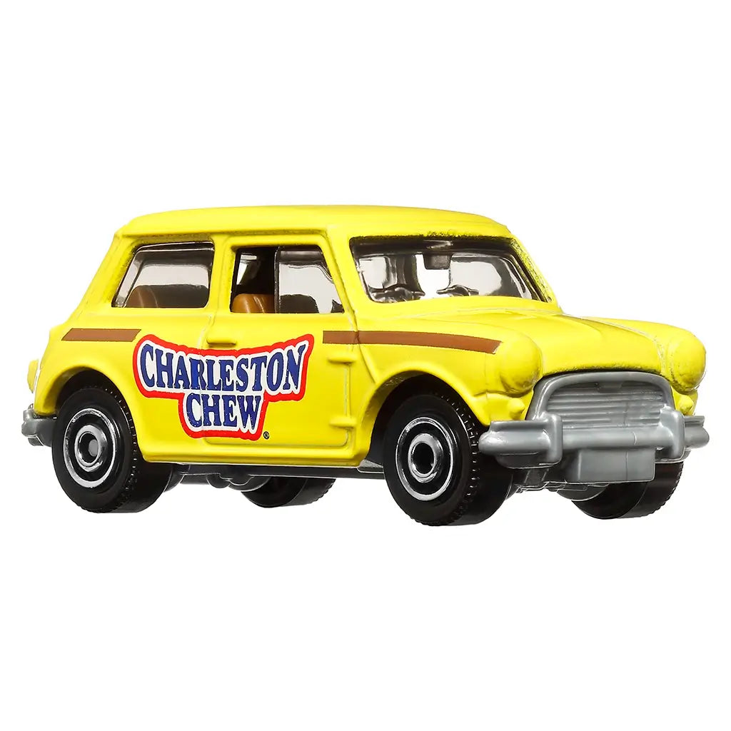 Diecast Matchbox Austin Mini Cooper toy car in yellow with Charleston Chew logo, brown side stripe, detailed silver grille and bumpers, shown from angled front side.
