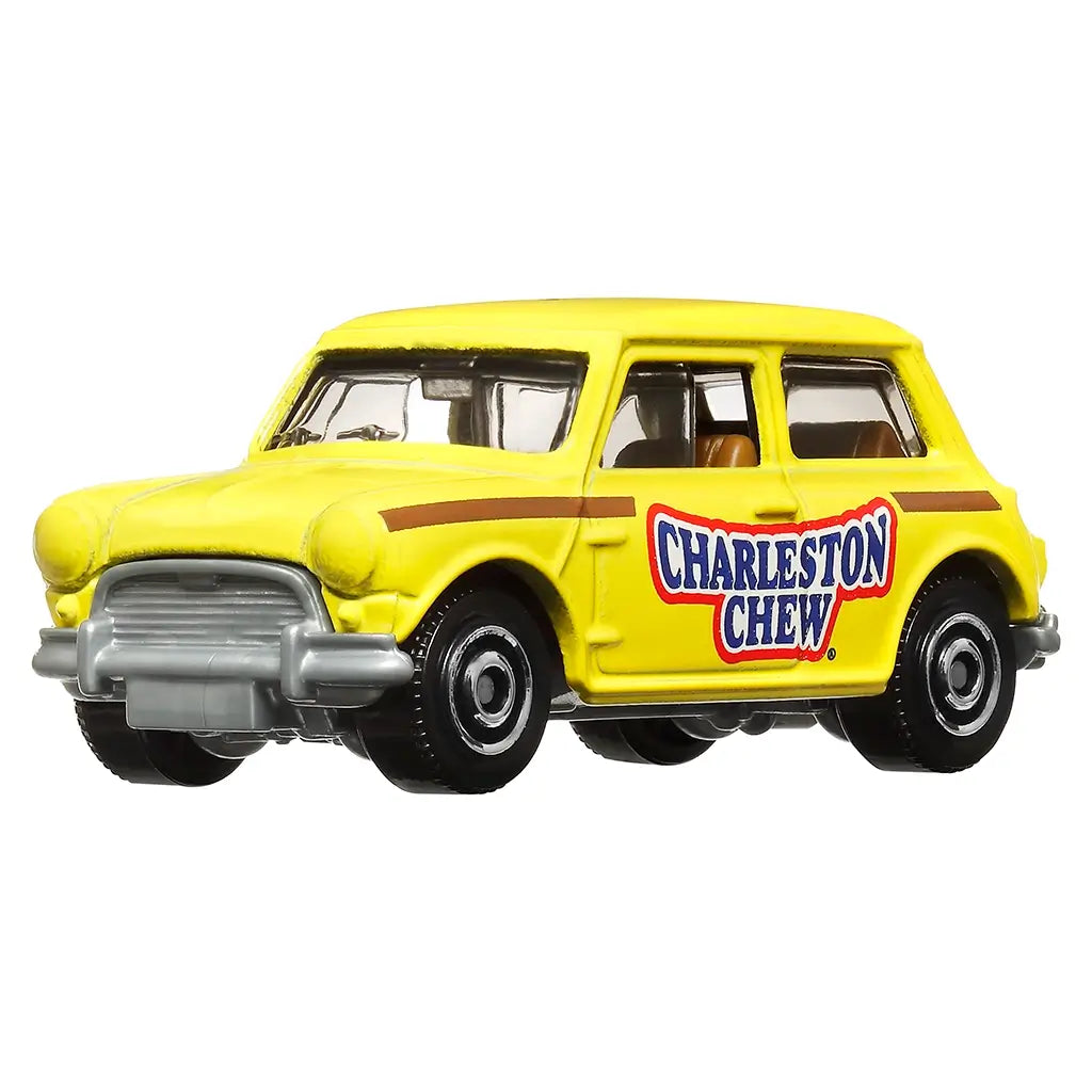 Matchbox 1964 Austin Mini Cooper diecast toy car in bright yellow with “Charleston Chew” candy logo on doors, silver bumpers, and black wheels, shown on white background.