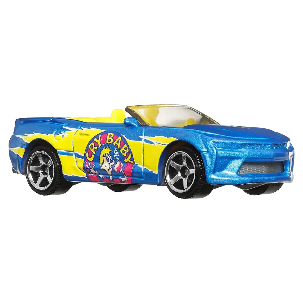 Side view of Matchbox 2016 Chevy Camaro convertible toy car painted in metallic blue and yellow with Cry Baby candy artwork, black tires, and silver rims for collectors.