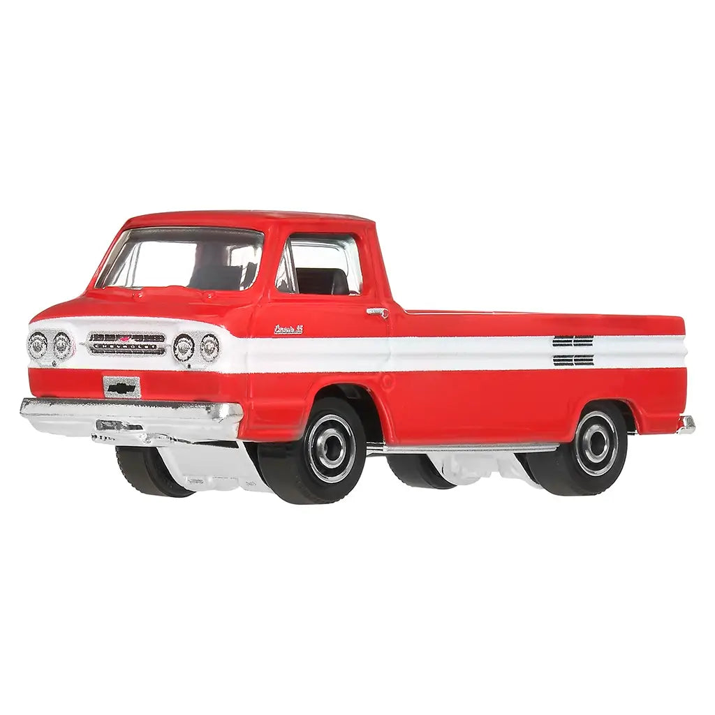 Close-up angled view of red and white Matchbox 1961 Chevy Corvair Rampside Pickup toy truck with functional opening ramp on the side, detailed chrome grille, and black wheels.