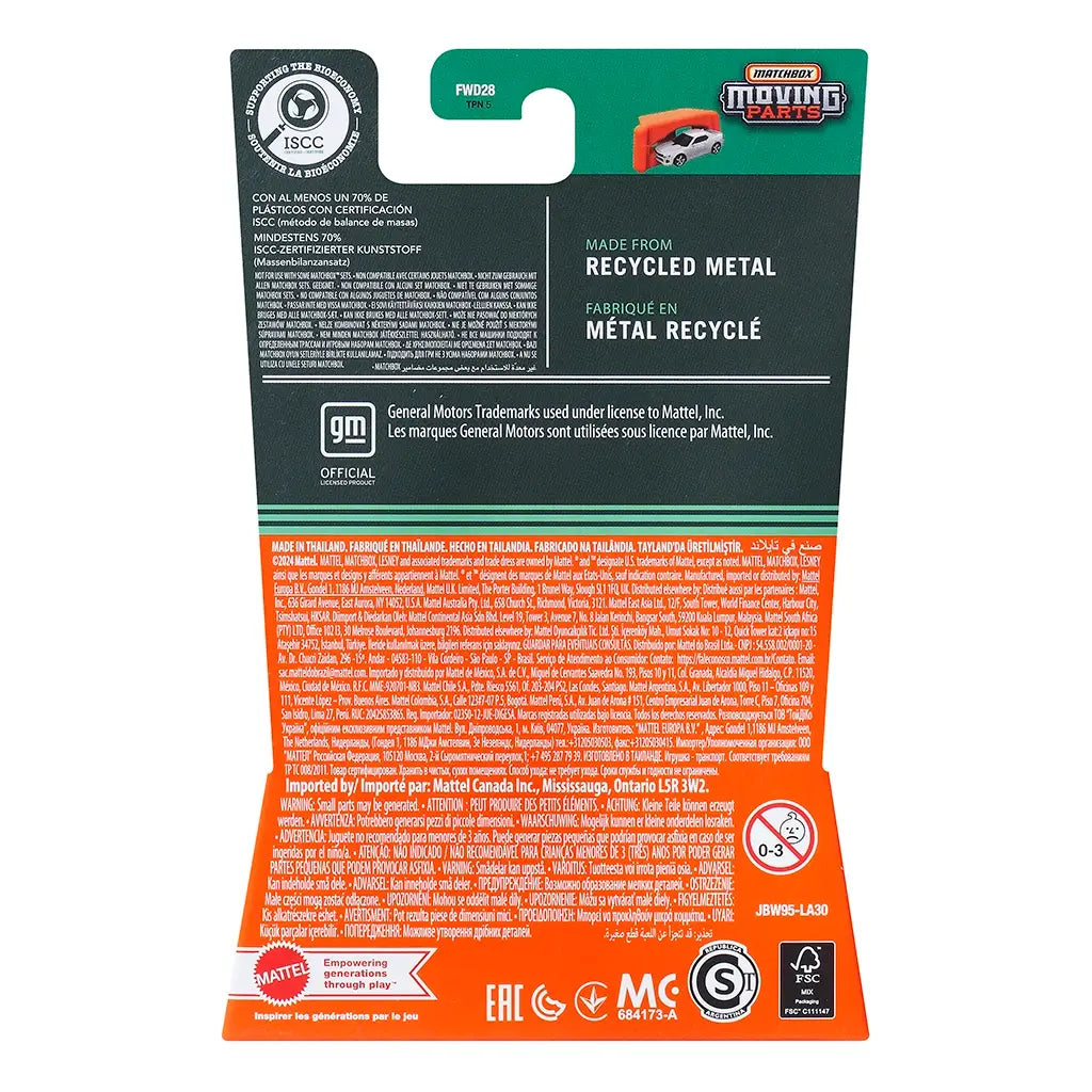 Black and orange Matchbox Moving Parts package back showing recycled material details, GM licensing, safety warnings, and multilingual product information for the diecast toy.
