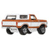 Die-cast Matchbox 1978 Ford Bronco toy car in orange and white with chrome details, rugged tires, and rear angled view, showcasing its vintage SUV design and collectible appeal.