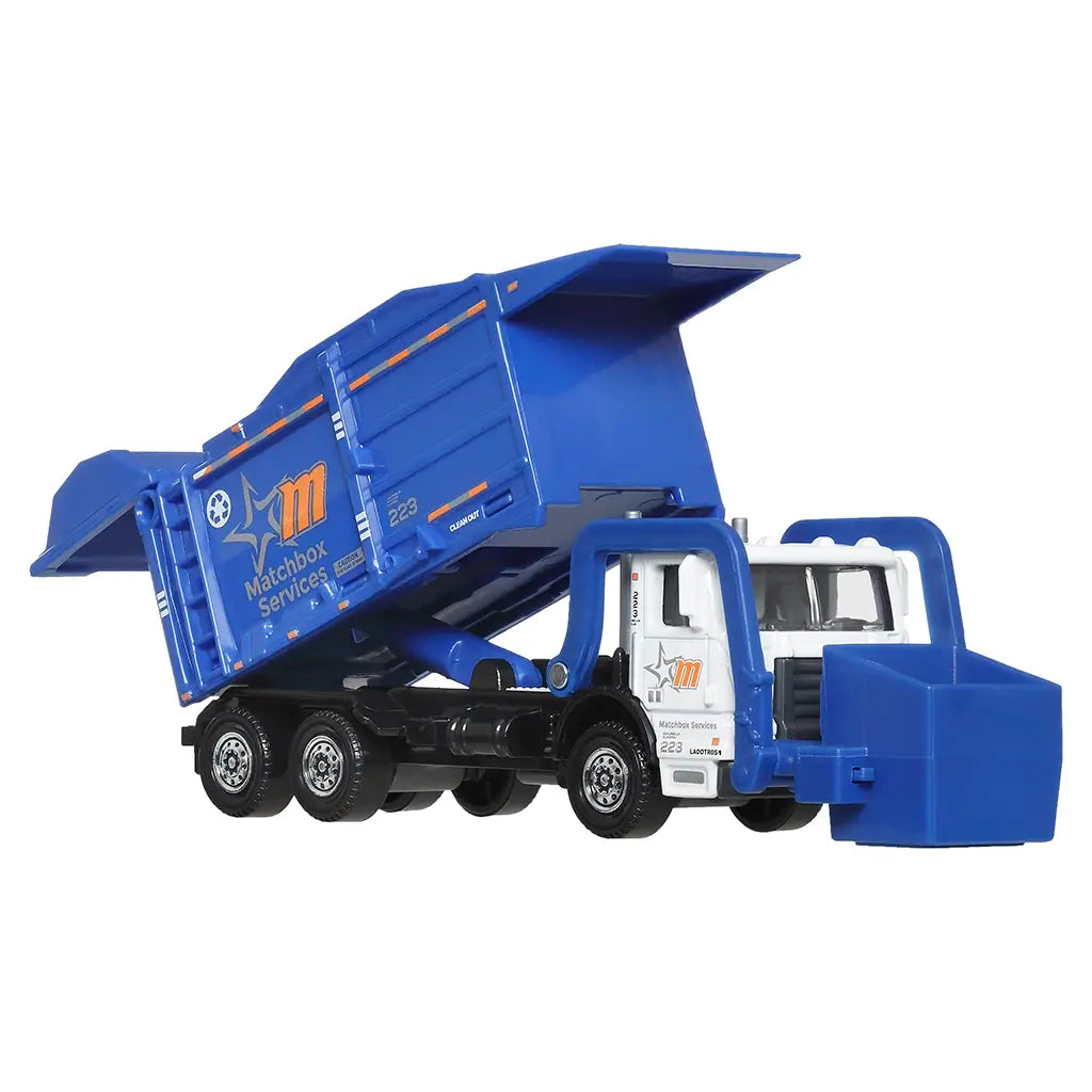 Matchbox Working Rigs Garbage King XL toy truck shown at an angled view with blue diecast body, white cab, articulated rear container, and detailed municipal service features against a white background.