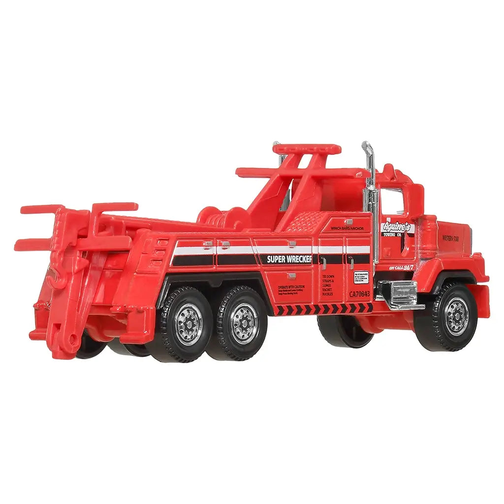 Red Matchbox Western Star 6900XD toy wrecker truck with six black wheels, chrome exhaust pipes, and detailed towing rig, shown angled rear view on plain white background.